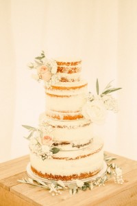 Semi naked sponge cake made with a tier of vanilla sponge, chocolate sponge and lemon and elderflower sponge